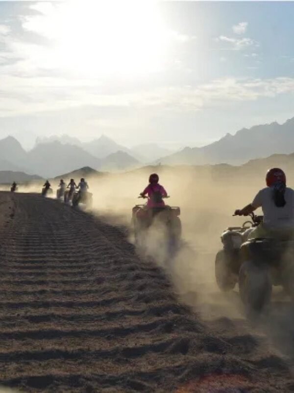 Group of happy tourists riding ATV quad bike safari in the Hurghada desert adventure