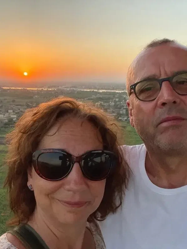A couple enjoying a sunrise hot air balloon flight over Luxor