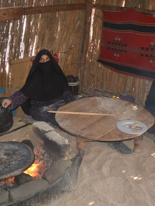 Bedouin women cooking and showing the tourists the Bedouin bread and their culture in the Hurghada desert jeep safari trip