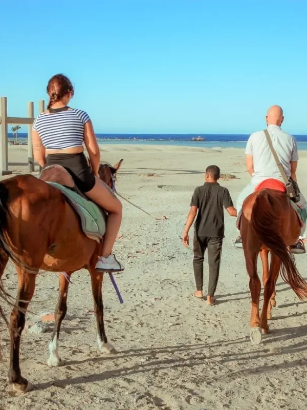 Tourist taking photos during horse ride in Hurghada