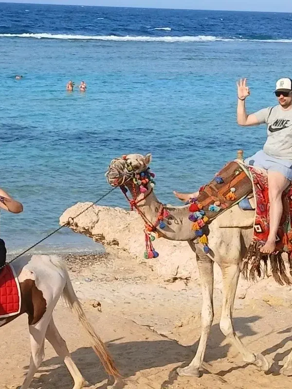 family sitting on the camel enjoying at Marsa Alam beach